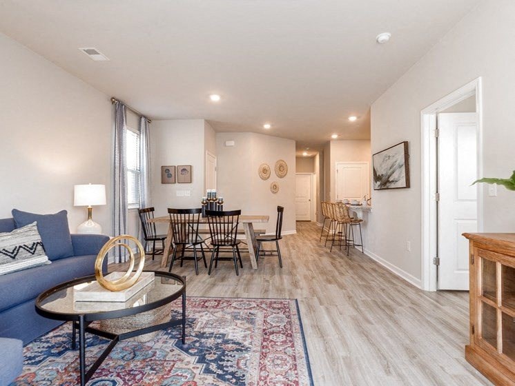 a living room with a couch and a table with chairs