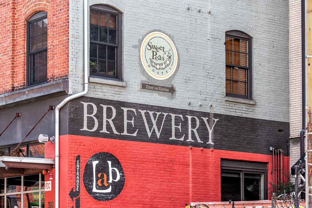 the side of a building with a sign that reads brewery