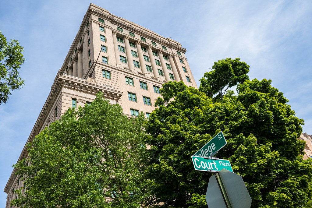 a street sign in front of a tall building
