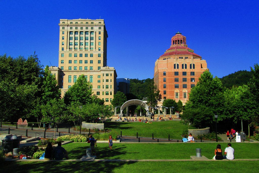 a park in the middle of a city with tall buildings