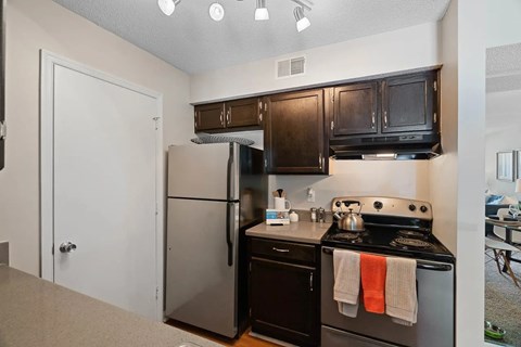 A kitchen with black appliances and wooden cabinets.