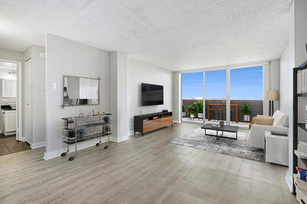 the living room of an apartment with a large window and