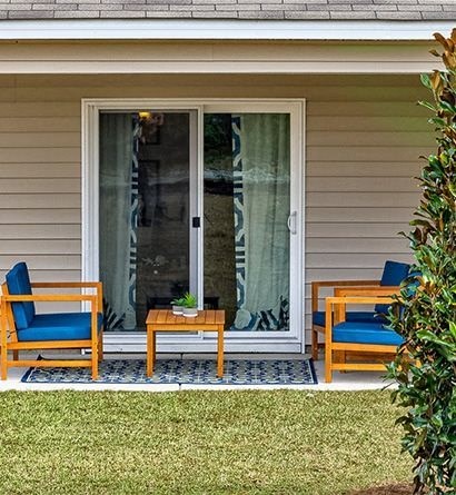 a porch with two chairs and a table