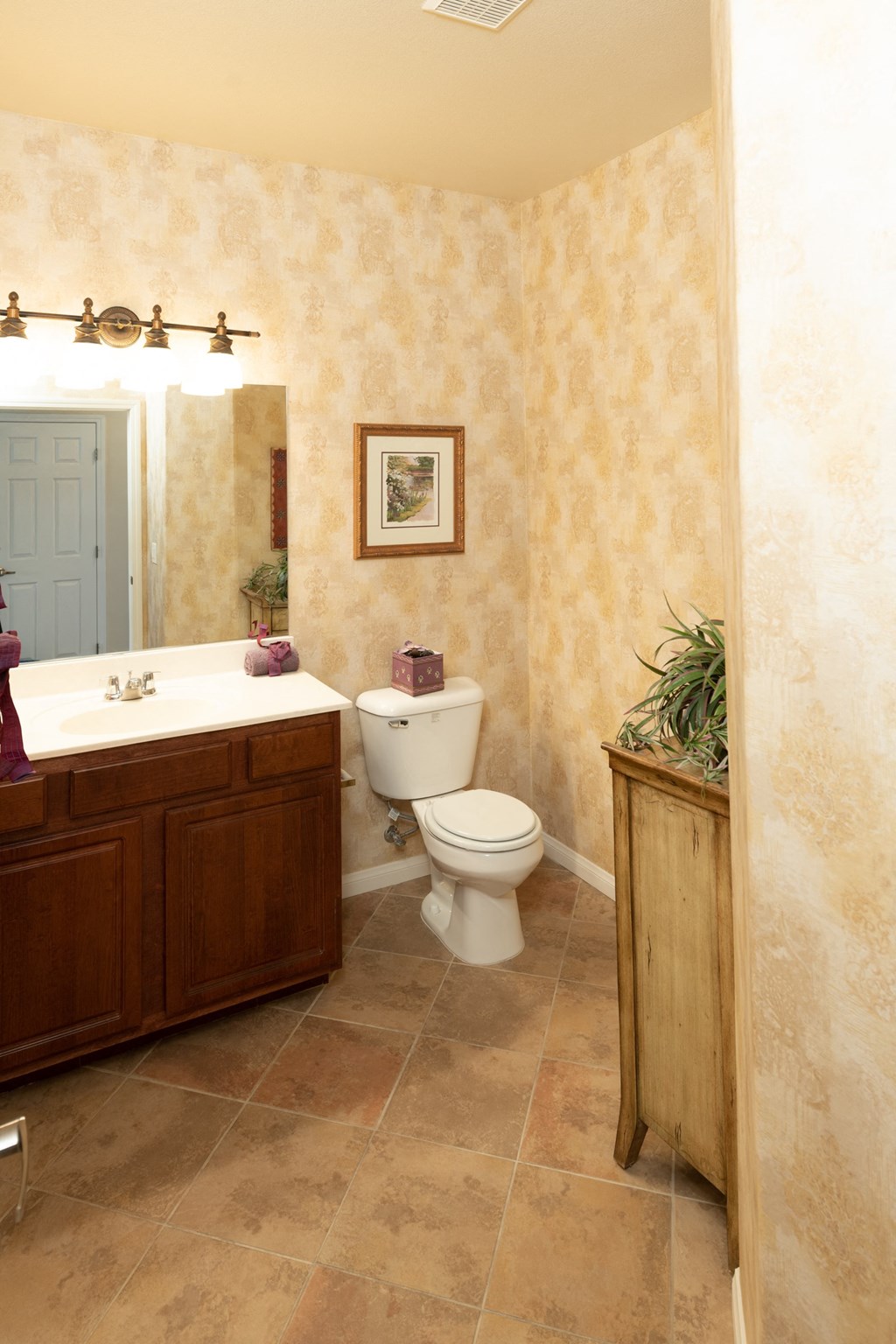 a bathroom with a toilet and a sink and a mirror