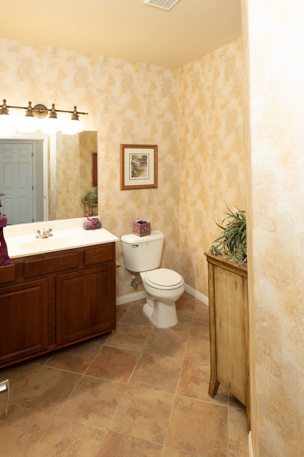 a bathroom with a toilet and a sink and a mirror