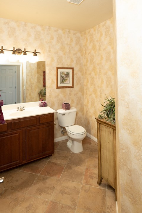 a bathroom with a toilet and a sink and a mirror