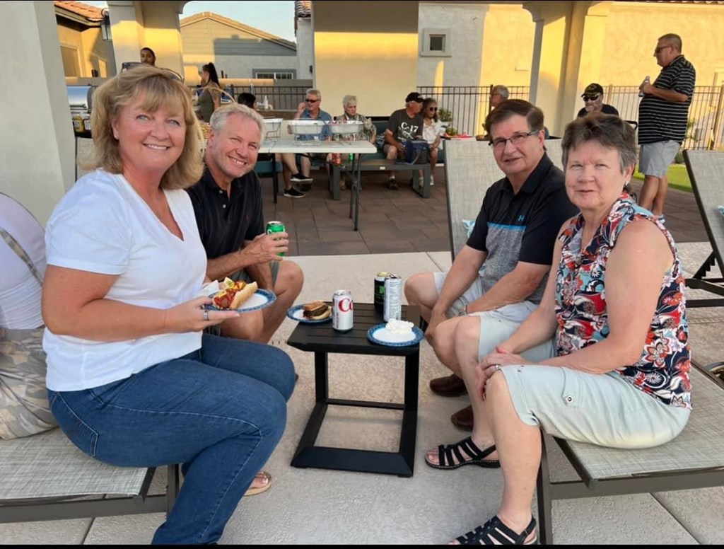 a group of people sitting around a table eating food