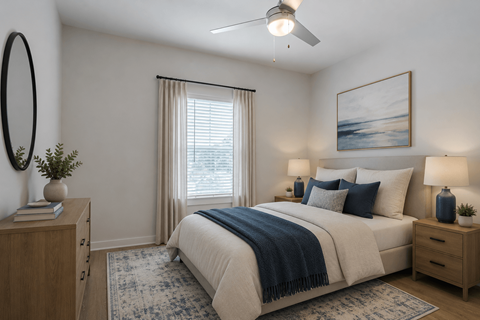 Spacious primary bedroom at Blue Sky Landing in College Park, GA featuring a ceiling fan, large windows, plush carpeting, and modern finishes in a brand-new one-, two-, and three-bedroom apartment home.