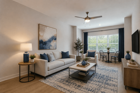 A living room with a white couch, a coffee table, and a painting on the wall.