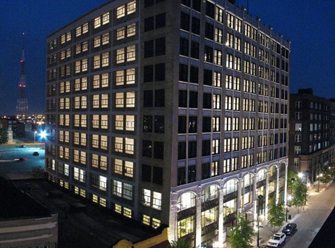 a tall building with many windows at night