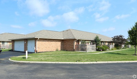 the front of a brick house with a lawn