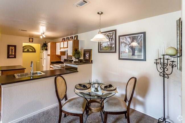 A dining room with a table set for two.