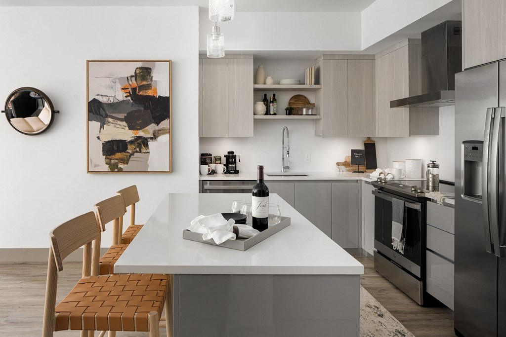 Pet-Friendly Apartments in Boca Raton, FL – CERU - Luxury kitchen with a center island stainless steel appliances and hardwood floors.