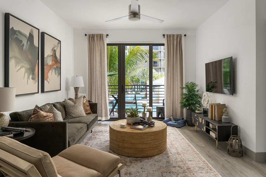 Luxury Boca Raton Apartments – CERU - a living room with a ceiling fan, hardwood floors, and a view of the balcony