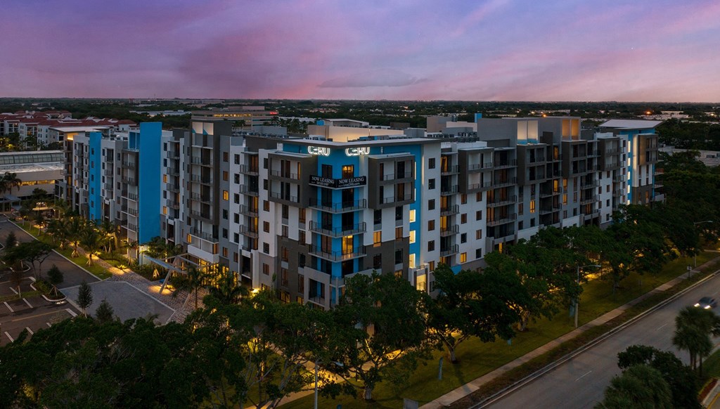Pet-Friendly Apartments in Boca Raton, FL – CERU - an aerial view of our luxury apartment building at dusk