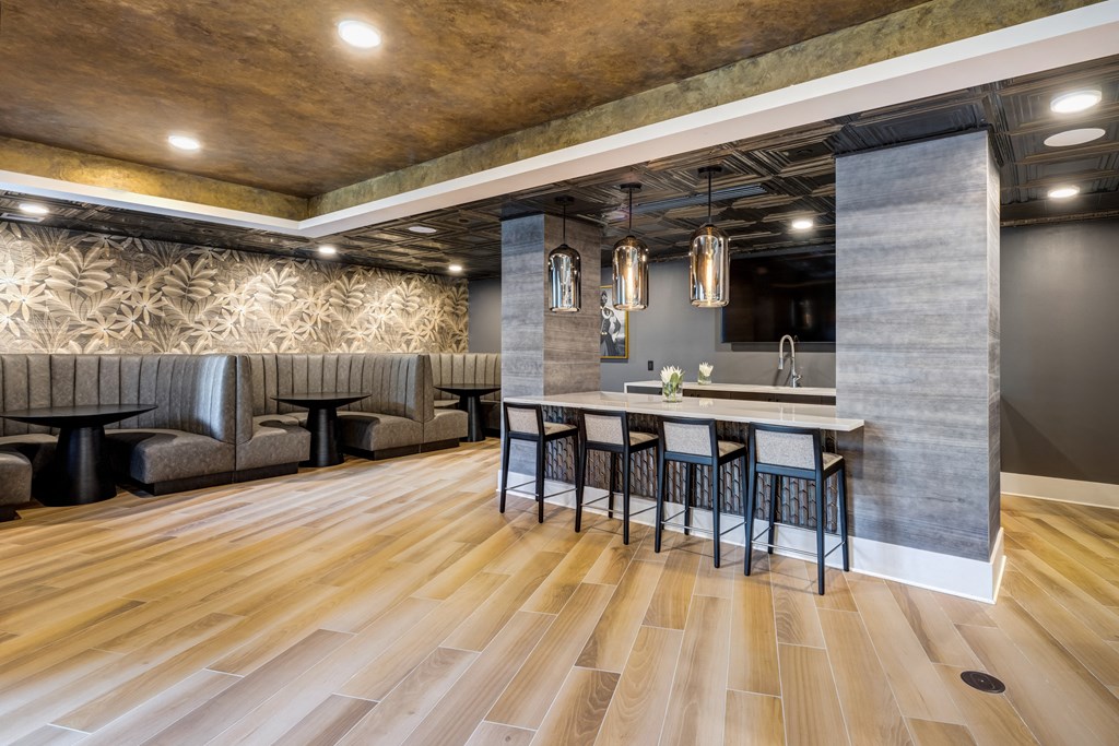 Luxury Boca Raton Apartments – CERU - a lobby with a bar and chairs and a table