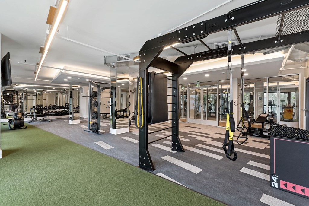 Boca Raton Apartments - CERU - a gym with weights and exercise equipment