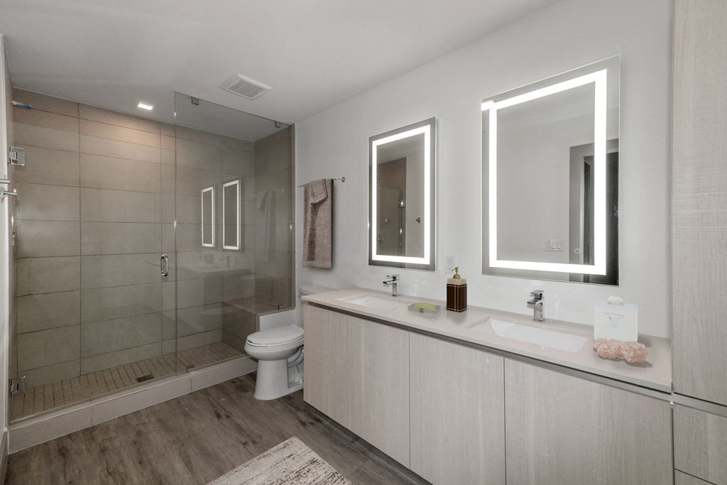 Boca Raton Apartments - CERU - a bathroom with a shower sink and mirror and a toilet