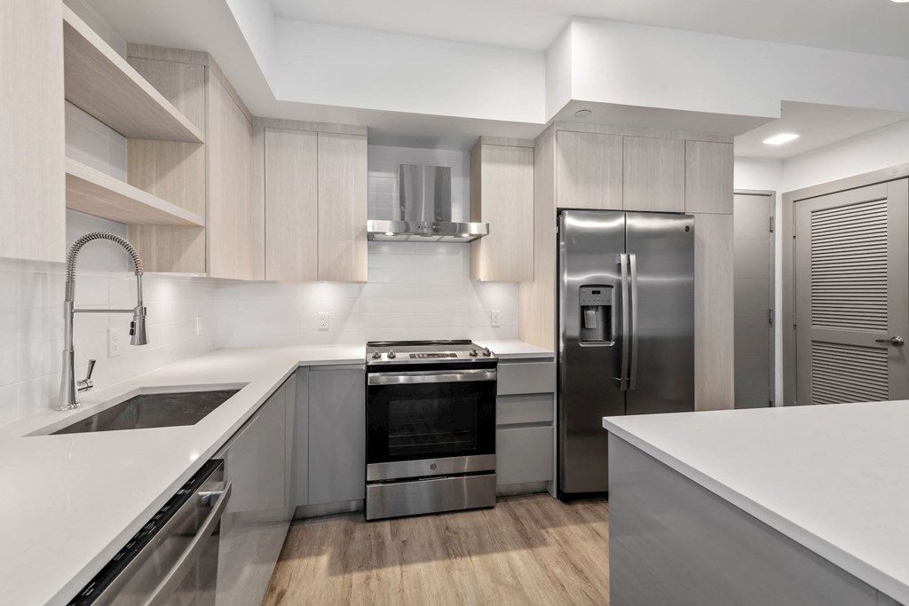 Apartments in Boca Raton for Rent – CERU - a kitchen with white counter tops and stainless steel appliances