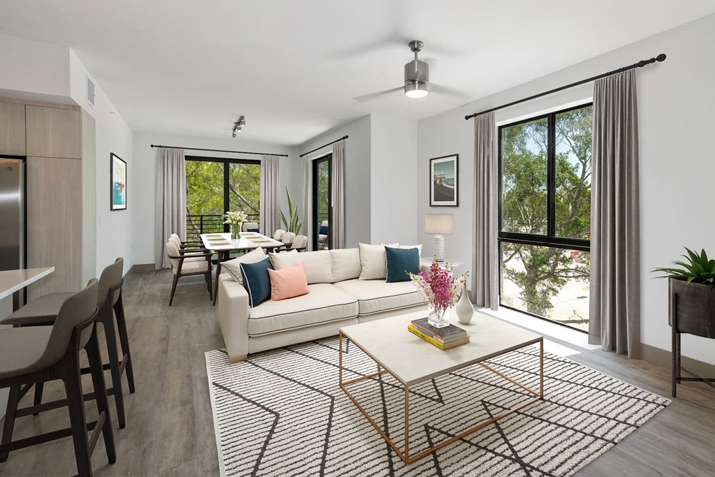 Luxury Boca Raton Apartments – CERU - a living room and dining room with large windows, ceiling fan, and hard wood floors