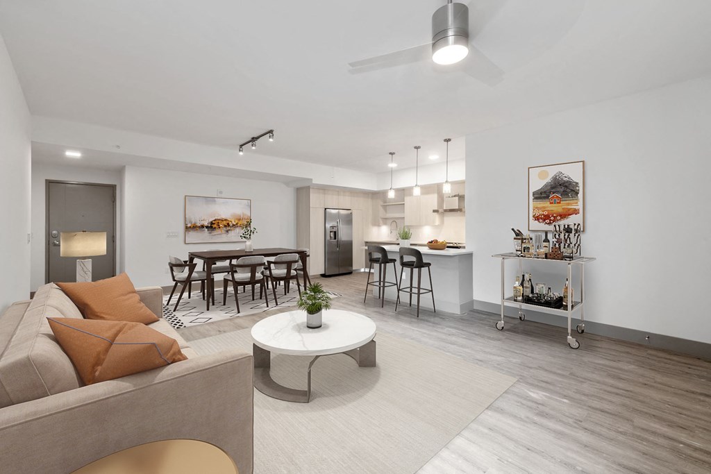 Pet-Friendly Apartments in Boca Raton, FL – CERU - a living room with a couch and a table, hardwood flooring and ceiling fan.