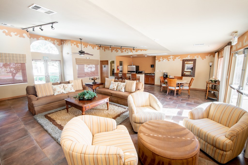 a living room with couches and chairs and a dining room