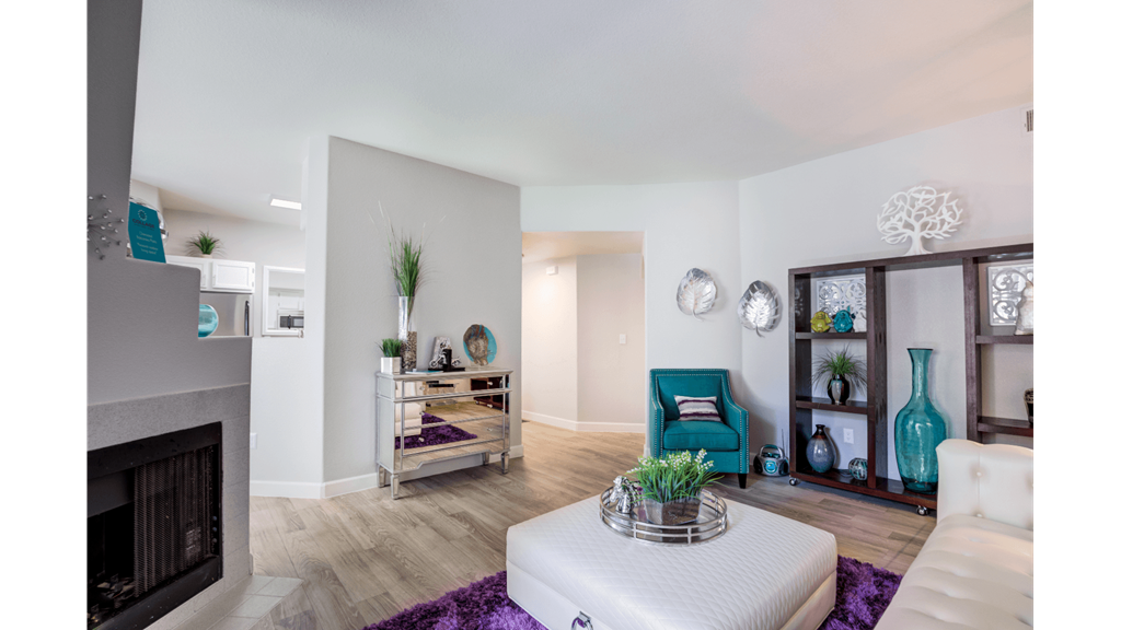 a living room with a fireplace and a white couch