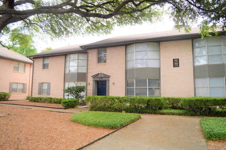 an apartment building with a walkway in front of it