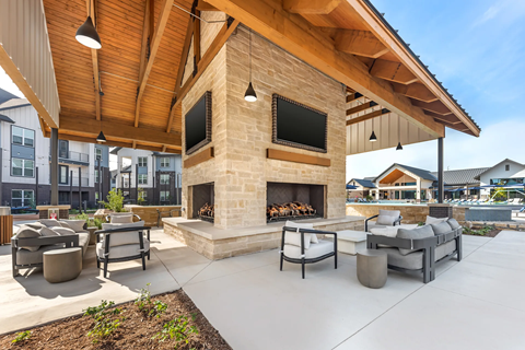 A patio with a fireplace and seating area.