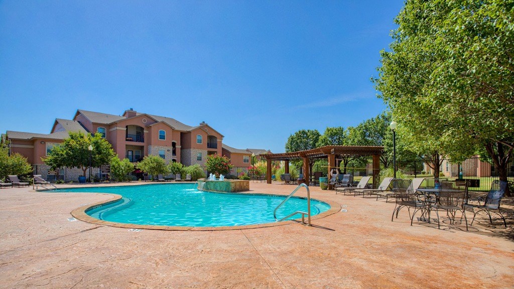 Resort Style Swimming Pool with Cabana and picnic area with tables and chairs and beach chairs