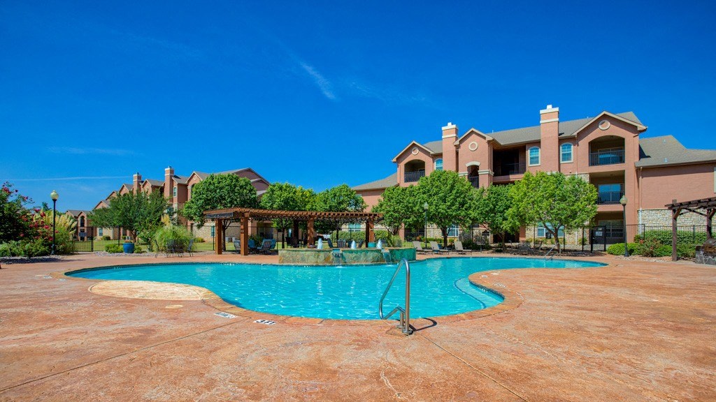 Resort Style Swimming Pool with Cabana and picnic area with tables and chairs and beach chairs