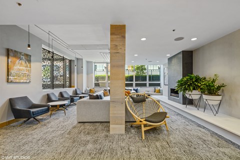 A modern office space with a large wooden column and comfortable seating.