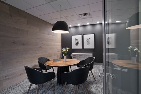 A modern dining room with a round table and chairs.