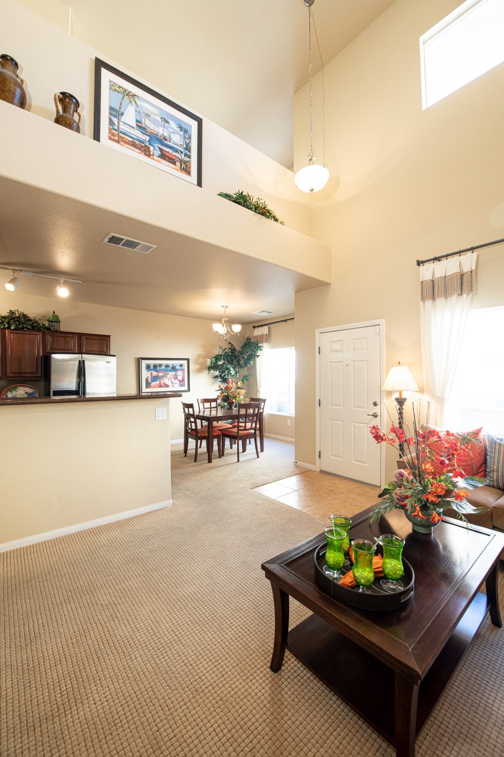 the view of a living room and kitchen from the dining room