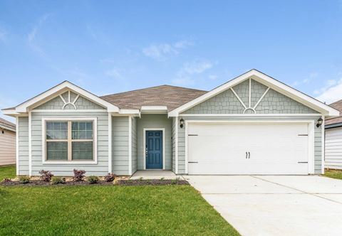 4 BR Apartments in North Denton, TX - Beall Way - Home Exterior with Driveway, Two-Car Garage, and Green Grass.