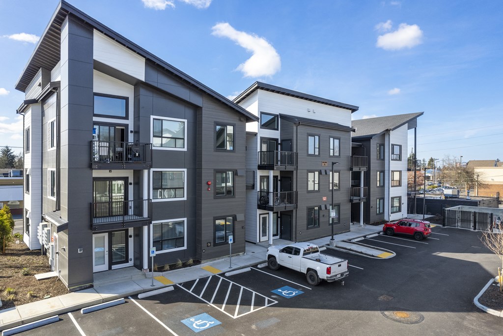 Apartments for Rent in Tacoma, WA - Pacific Ridge - Grey and White Building Exterior with Street View and Parking