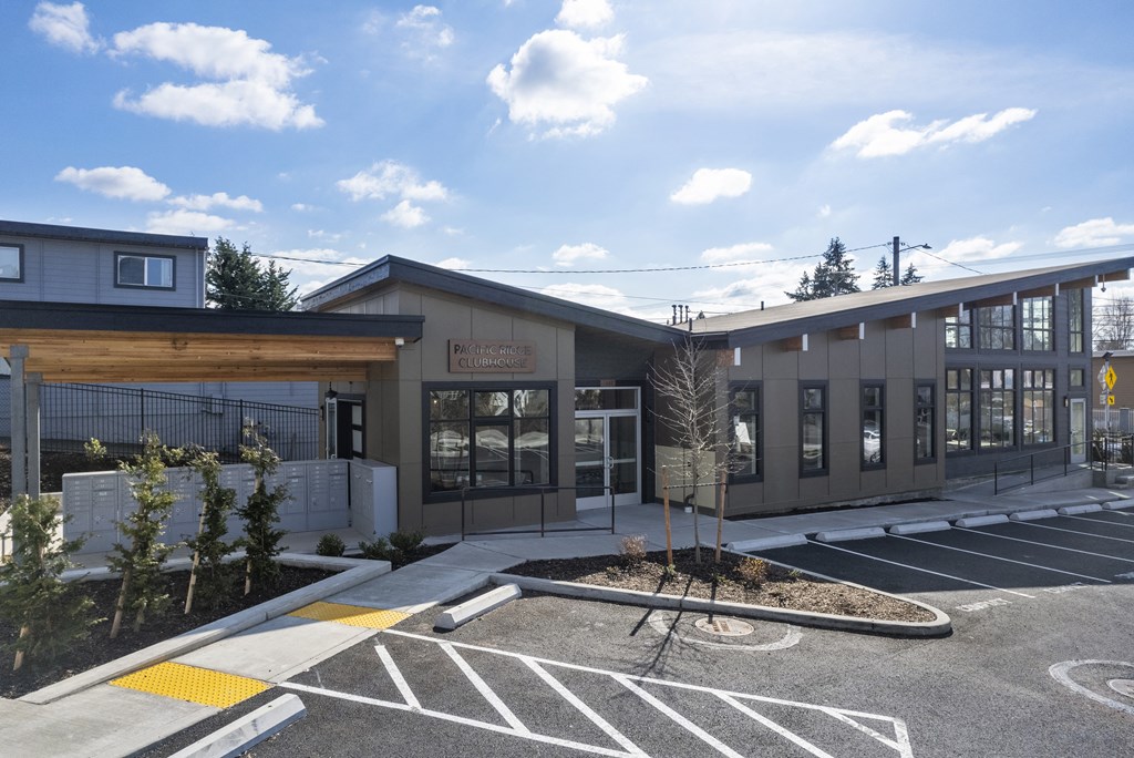 leasing center exterior with a parking lot in front of it,