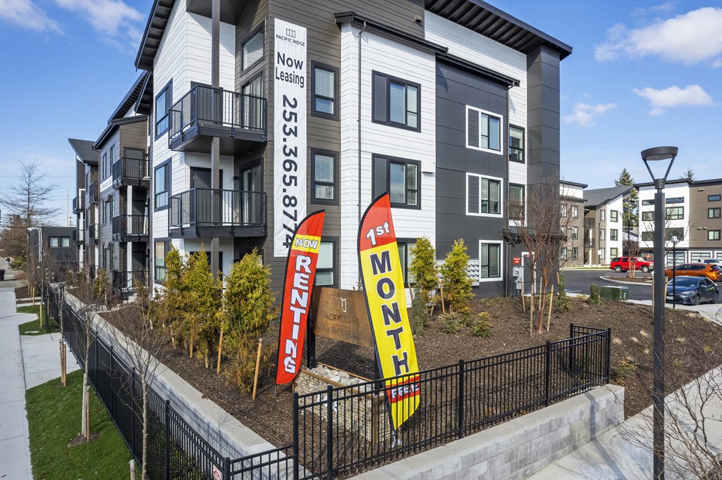 a view of a building with two banners in front of it,