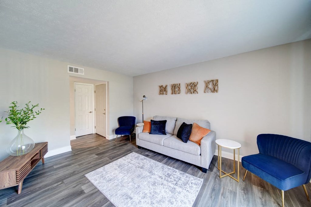 a living room with a couch and two chairs