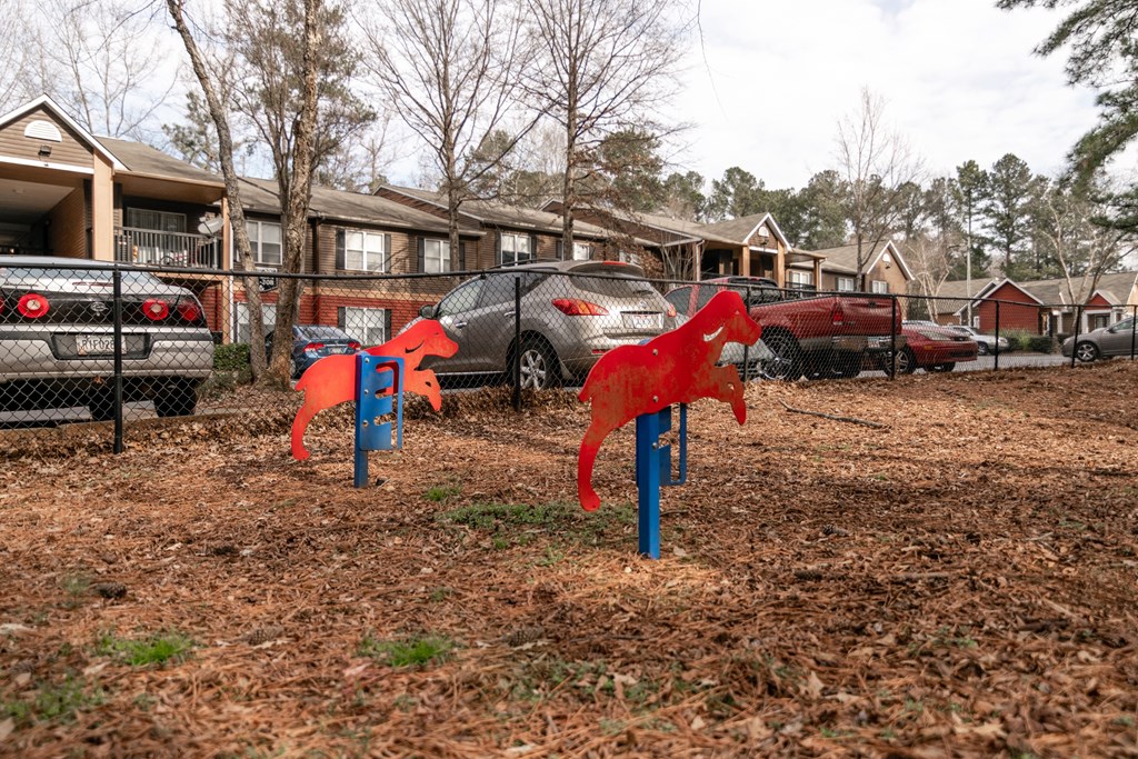 Fenced pet park with agility equipment at Flats at River View apartments in Duluth, GA, near Lawrenceville.