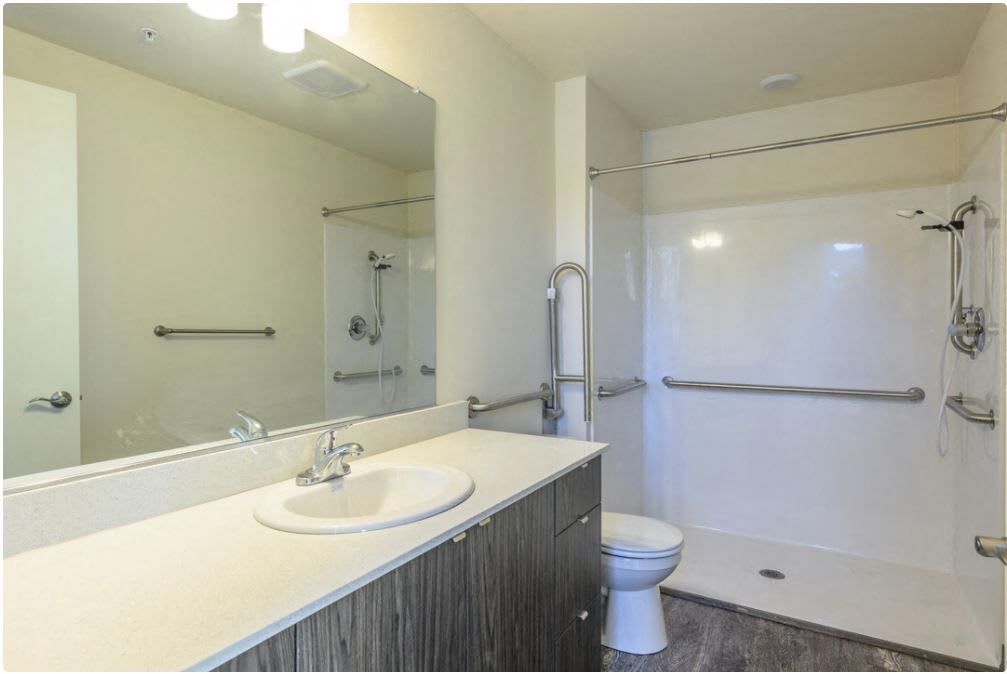 a bathroom with a sink toilet and shower