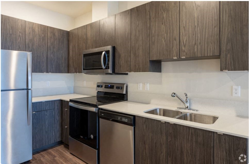 a kitchen with a stove top oven next to a sink