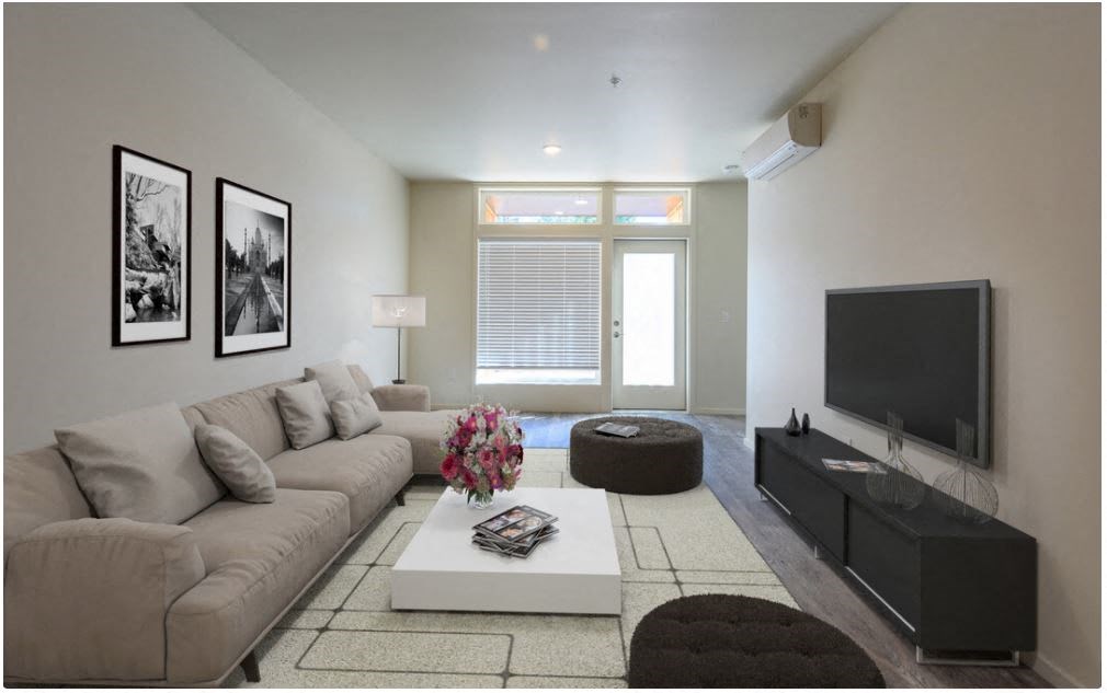 a living room filled with furniture and a flat screen tv