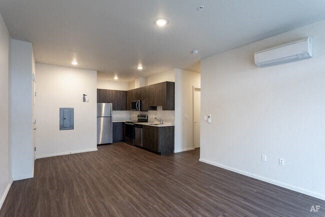 a kitchen with a refrigerator freezer and a stove top oven