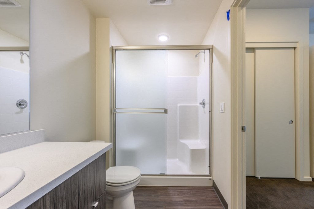 a bathroom with a toilet sink and shower