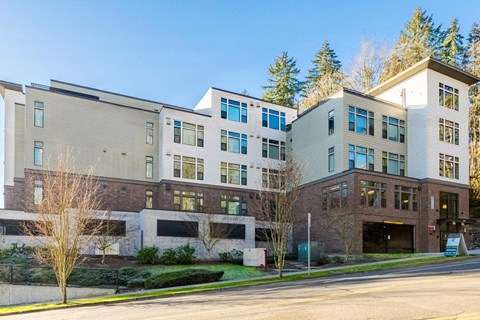 A modern multi-story building with a mix of brick and panel facades at Emerald Crest, Bothell, WA 98011