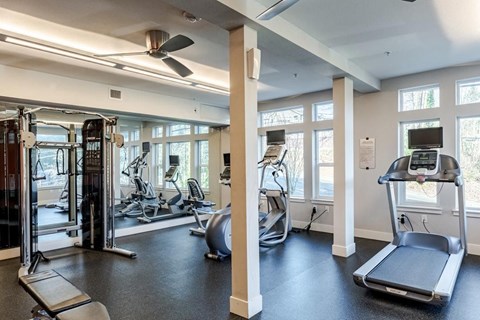 A gym with treadmills, elliptical machines, and other exercise equipment at Emerald Crest, Bothell, WA 98011