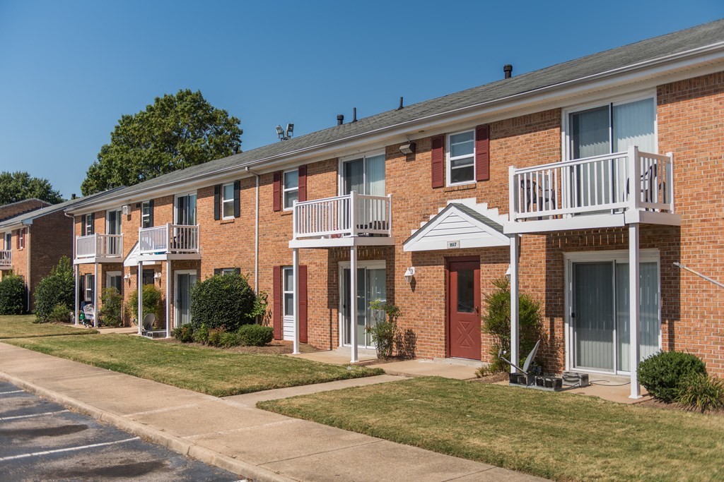 an exterior view of a brick apartment building with balconies