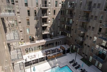 A large atrium with a pool and a staircase.