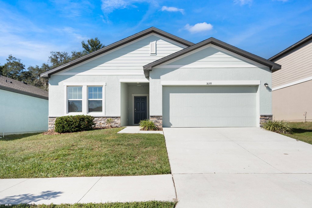 A house with a garage door that says 310 on it.